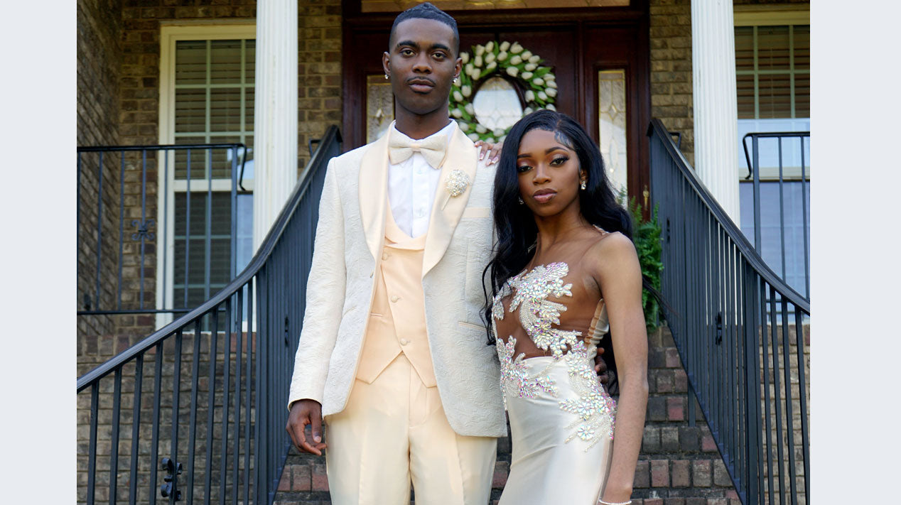 guy wearing ivory prom tuxedo with date