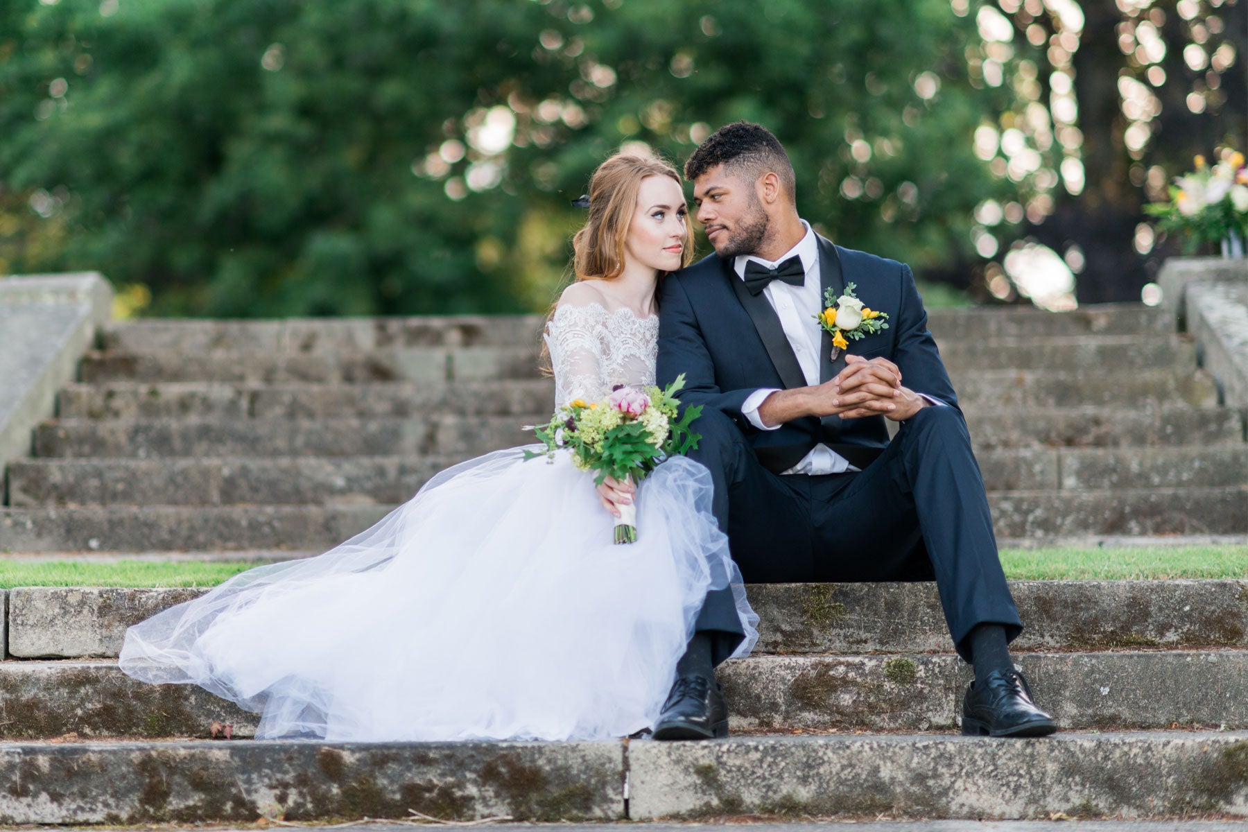 groom wearing navy tuxedo with bride at wedding