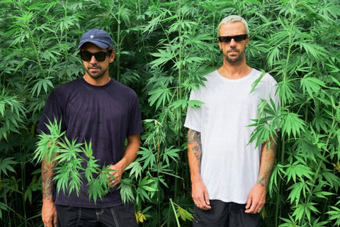 afends models stood in the afends hemp farm in byron bay australia. The models are half covered by hemp pants.