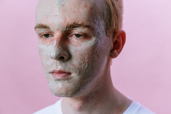 man's face with moisturizing mask on face