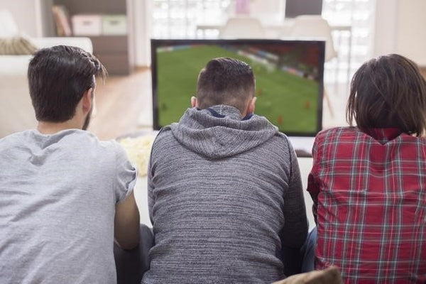 three men in front of the TV with their backs to the camera