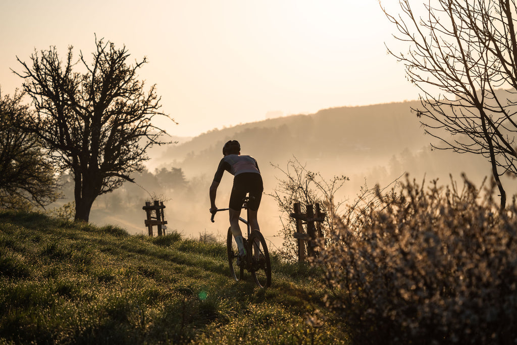 Lukas on a bike in a nature at sunset