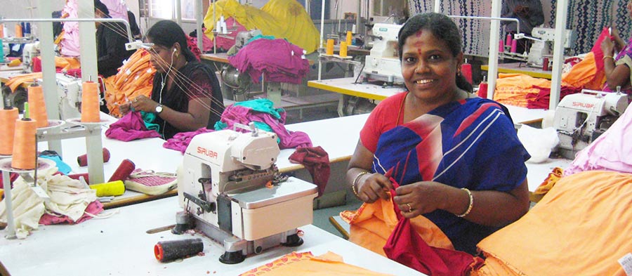 Intian tehtaan ompelija tekemässä trikootuotteita.