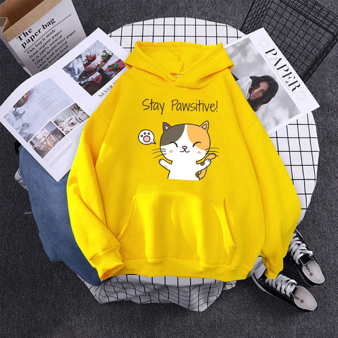 yellow color hoodie with cartoon cat print stated stay pawsitive happy quote on it