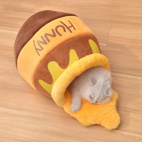 cat sleeping peacefully inside a honey jar shape cat bed