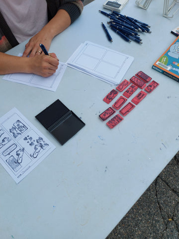 Close up of the Trail Library workshop, with hand-carved stamps and comic panels for children to make their own artwork with.