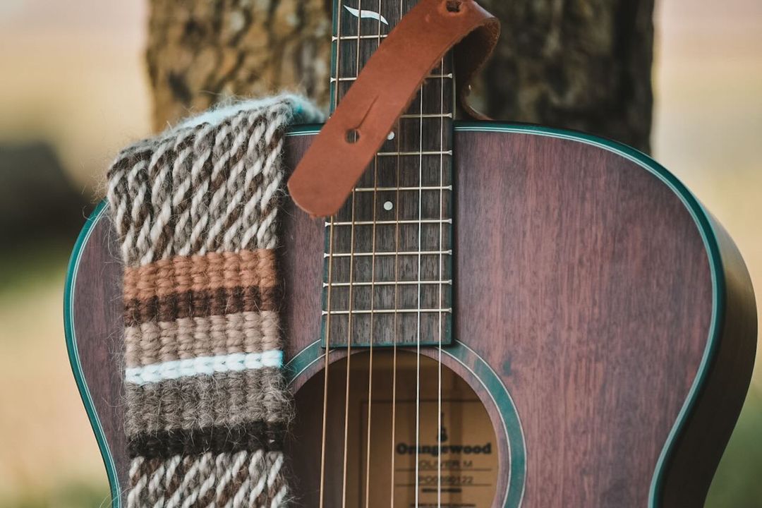 Orangewood Oliver Mahogany with a custom woven guitar strap.