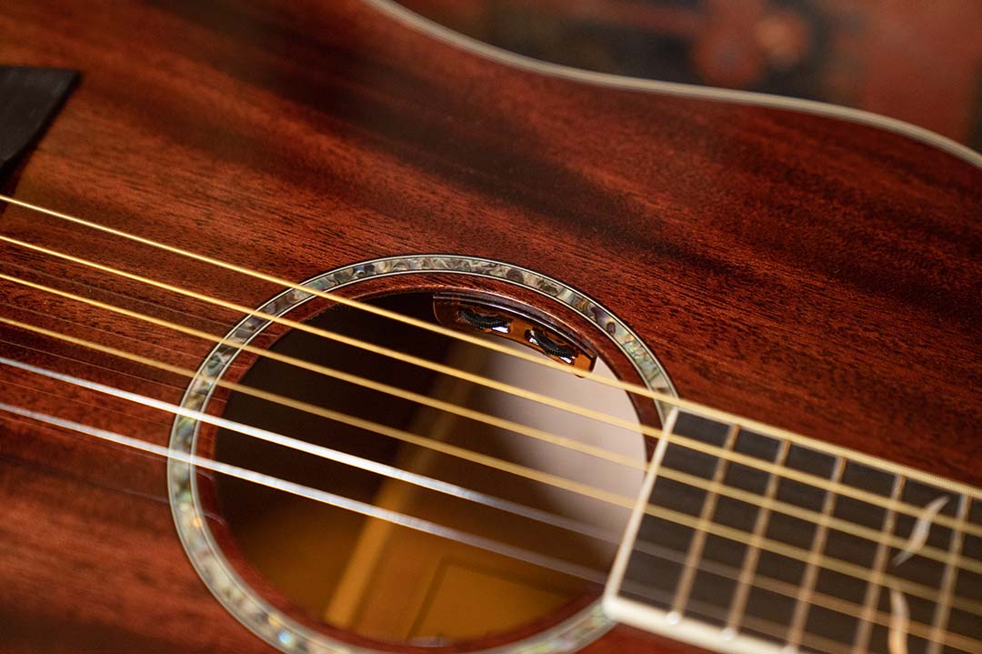 Detail shot of a solid top mahogany guitar with LR Baggs Bronze pickups