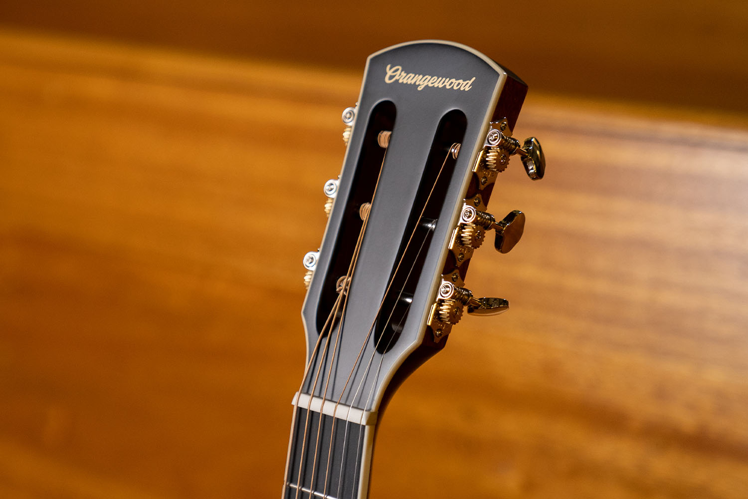 Slotted headstock with orangewood logo