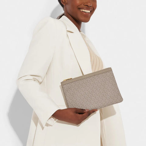 Model holding Katie Loxton Pouch - Signature Taupe