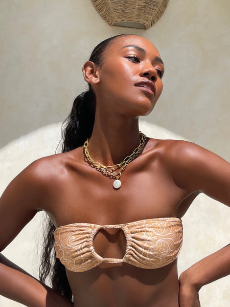 girl in bikini wearing pearl and gold chain necklace
