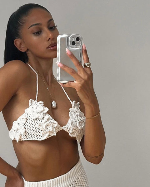 a girl taking a selfie in knit set and large baroque pearl necklace