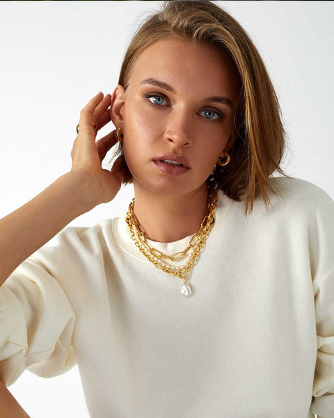 girl wearing pearl and gold layered necklace