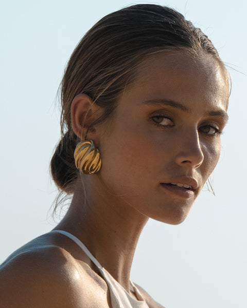 portrait with gold statement earrings