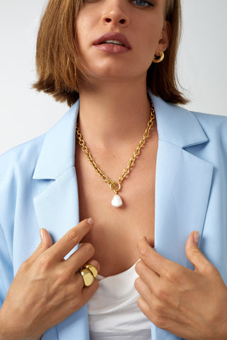 working girl wearing pearl and gold chain necklace