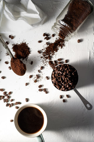 Coffee beans spilled on white table