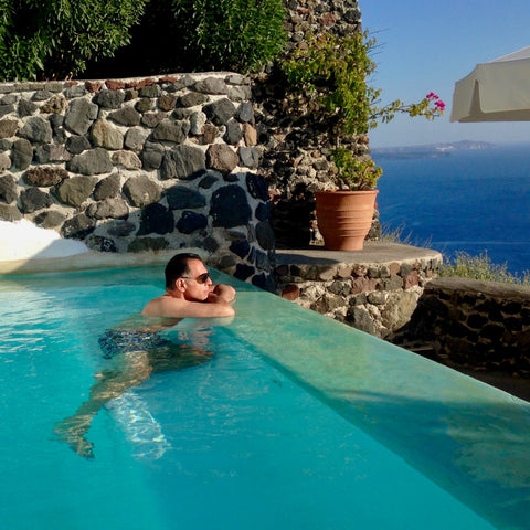 Gregory Cole, co-founder of the niche fragrance brand The Bubble Collection, enjoying the pool at his suite at Perivolas Hotel in Oia, Santorini
