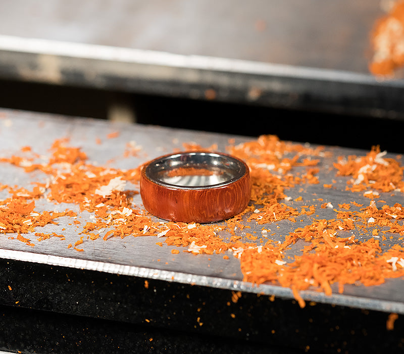 The finished ring laying on a lathe bed.