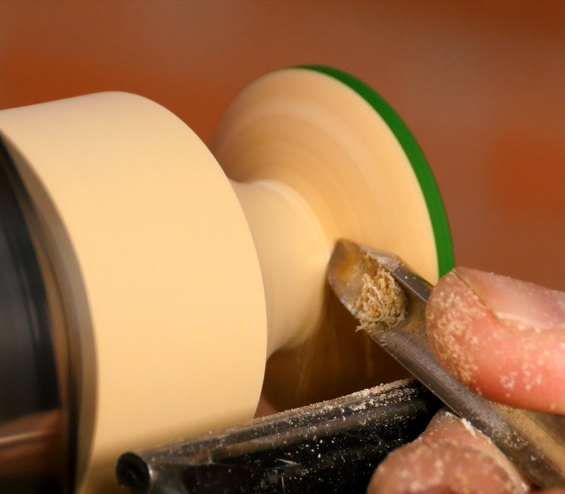 Refining the shape with a spindle gouge.