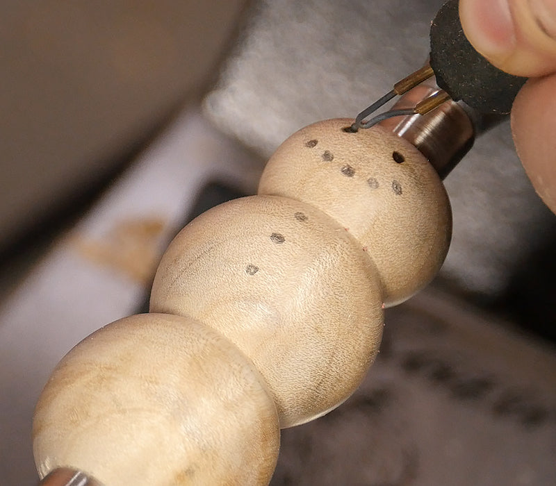 Adding eyeballs with a wood burner.