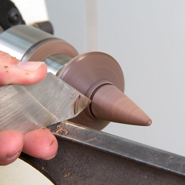 Adding a decorative groove with a narrow parting tool.