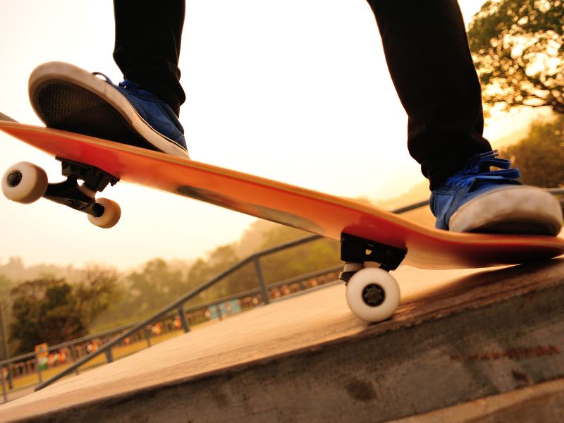 Skateboarder riding on ledge
