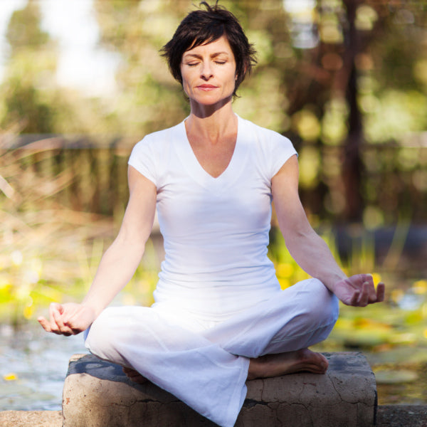 A woman meditates cross-legged