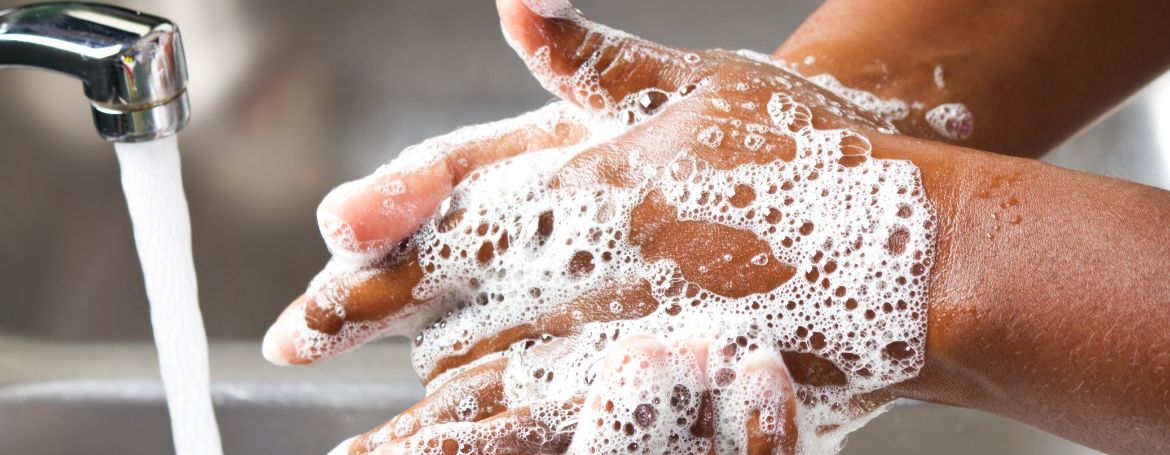 Soapy hand being rinsed under water, symbolising effective cleansing and hydration with premium hand wash.