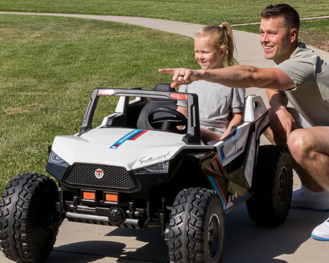 Parent Teaching Child while Riding the 24V AWD Dune Racer Electric Power Wheel Ride on Car for Kids