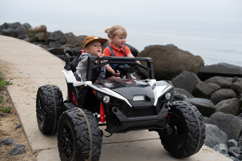 Children riding the 24V All Wheel Drive Dune Racer Power Wheels Ride On Car for Kids