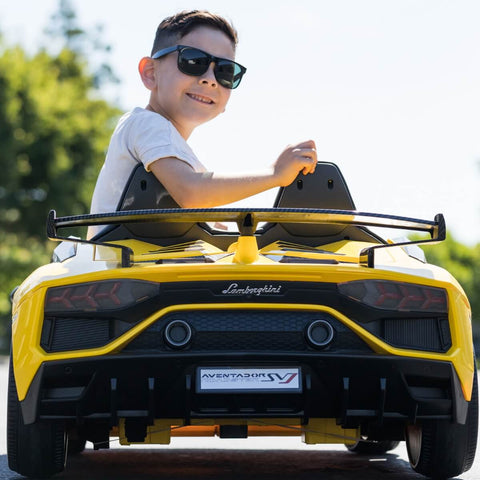 Child wearing sunglasses riding the bestselling 24V high speed lamborghini aventador power wheels ride on car for kids