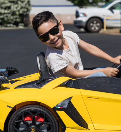 child happily riding the lamborghini aventador drift car