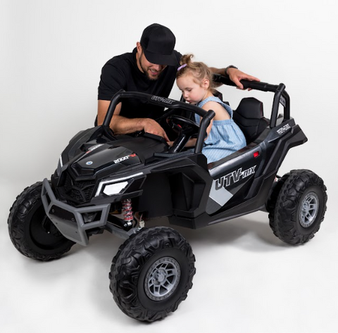 parent and child with the XXL UTV power wheel