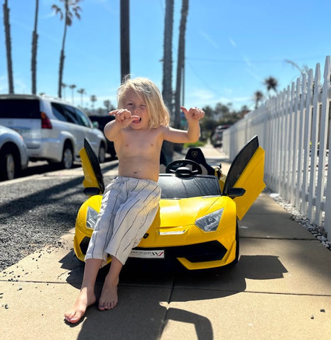 Kid playing with his 24V 2-Seater High Speed Lamborghini Aventador Drift Car for Kids