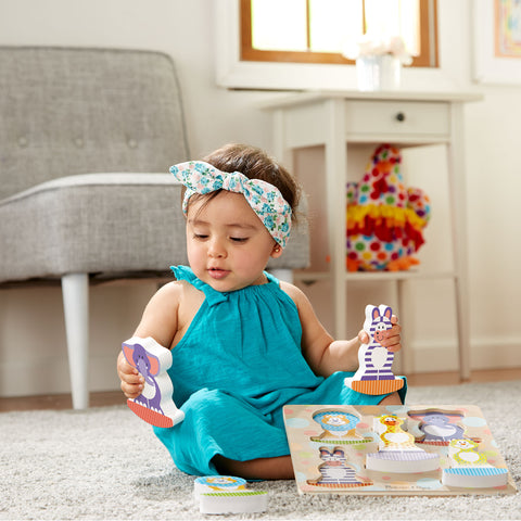Baby playing with Melissa & Doug wooden puzzle