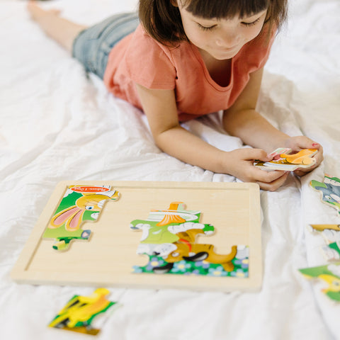 Girl playing with Melissa & Doug wooden puzzle