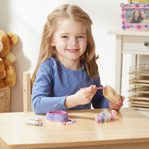 Girl decorating Melissa & Doug Heart-Shaped Box Craft