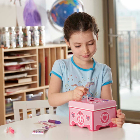 Girl decorating Melissa & Doug wooden jewelry box