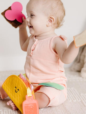 Girl playing with taco toy