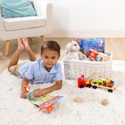 Boy playing with Melissa & Doug Sticker WOW activity pad in his Easter basket