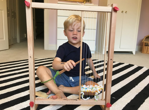 Boy playing with loom