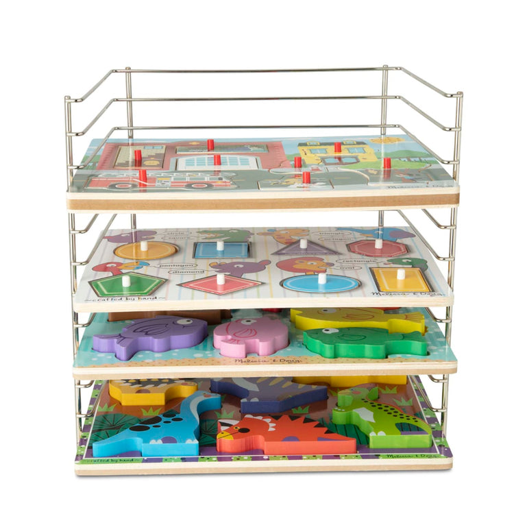 The loose pieces of the Melissa & Doug Multi-Fit Metal Wire Puzzle Rack For Up To a Dozen 12-Inch-Wide, 0.75-Inch Deep Wooden Puzzles