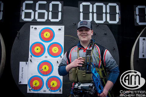 Bodie Turner standing next to his last three arrows of his 660 score with his Hoyt Invicta. 