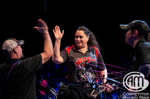 Catherine Papagni celebrates her victory in the Women's Masters Open Division with a high five.