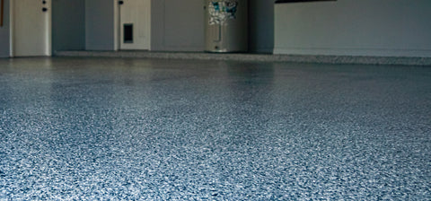 An image of a flake epoxy garage floor with Easy Cove wall basing.