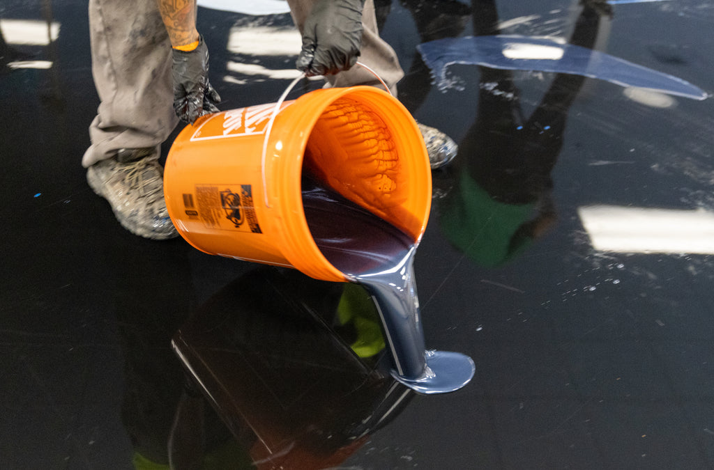 Epoxy resin flooring contractors working safely with epoxy resin during a project.