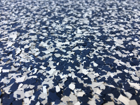 An image of a floor with broadcasted vinyl flakes waiting for an epoxy resin topcoat.