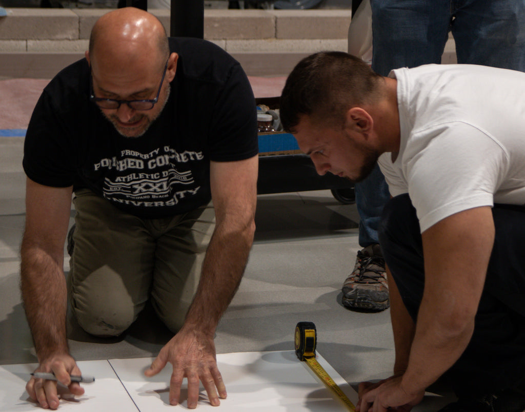 Polished Concrete University instructor with student preparing floor.