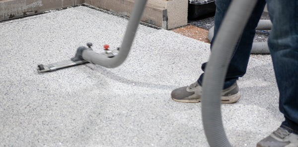 Flooring contractor troubleshooting epoxy resin installation by preparing the surface.