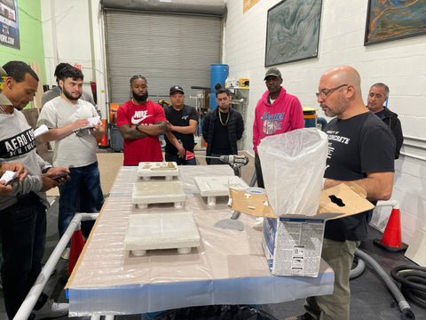 An image of a Polished Concrete University teacher showing contractors how to handle concrete slabs.